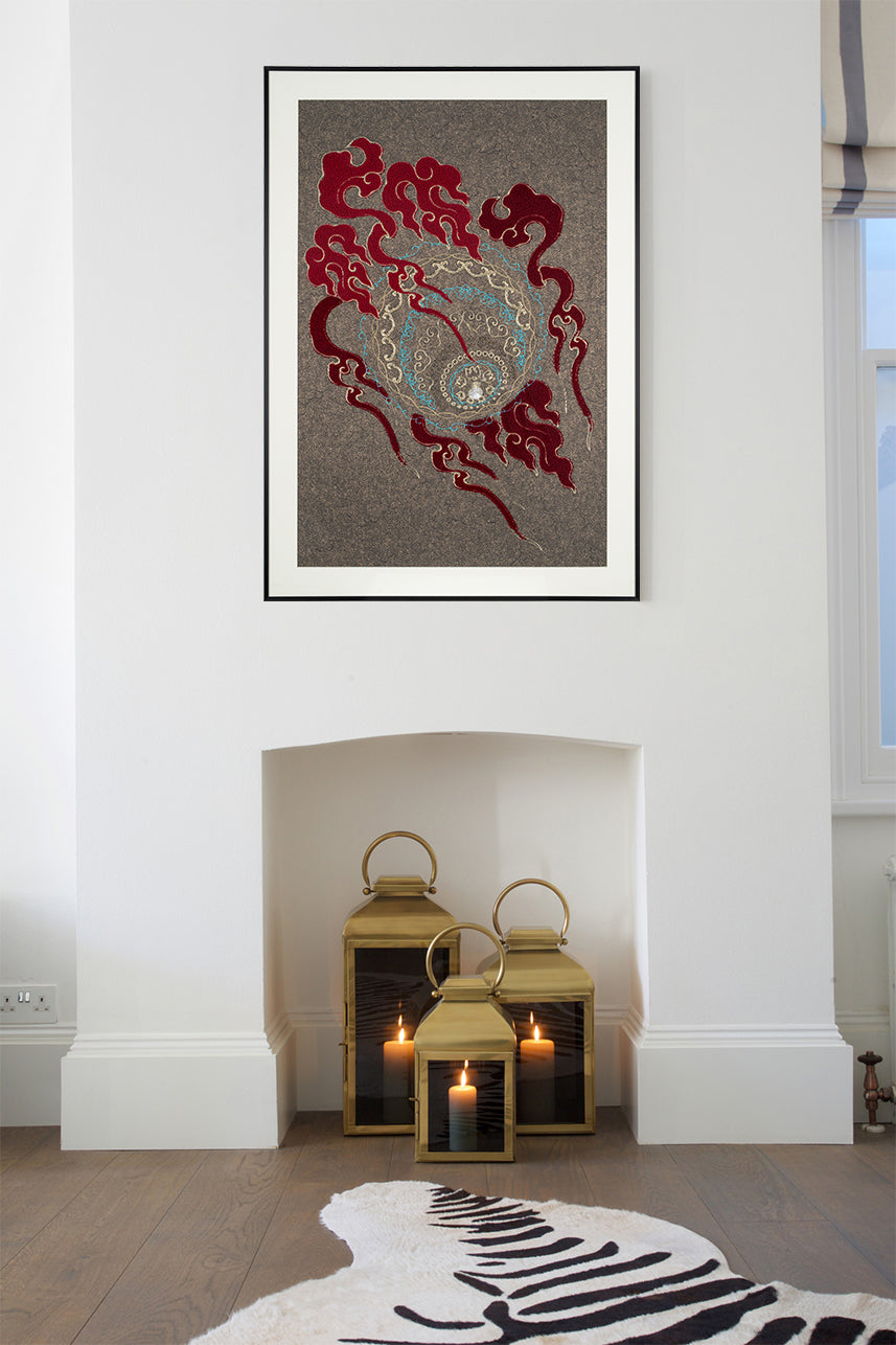 Framed embroidery artwork featuring a lion ball play design with ball patterns displayed over a fireplace.
