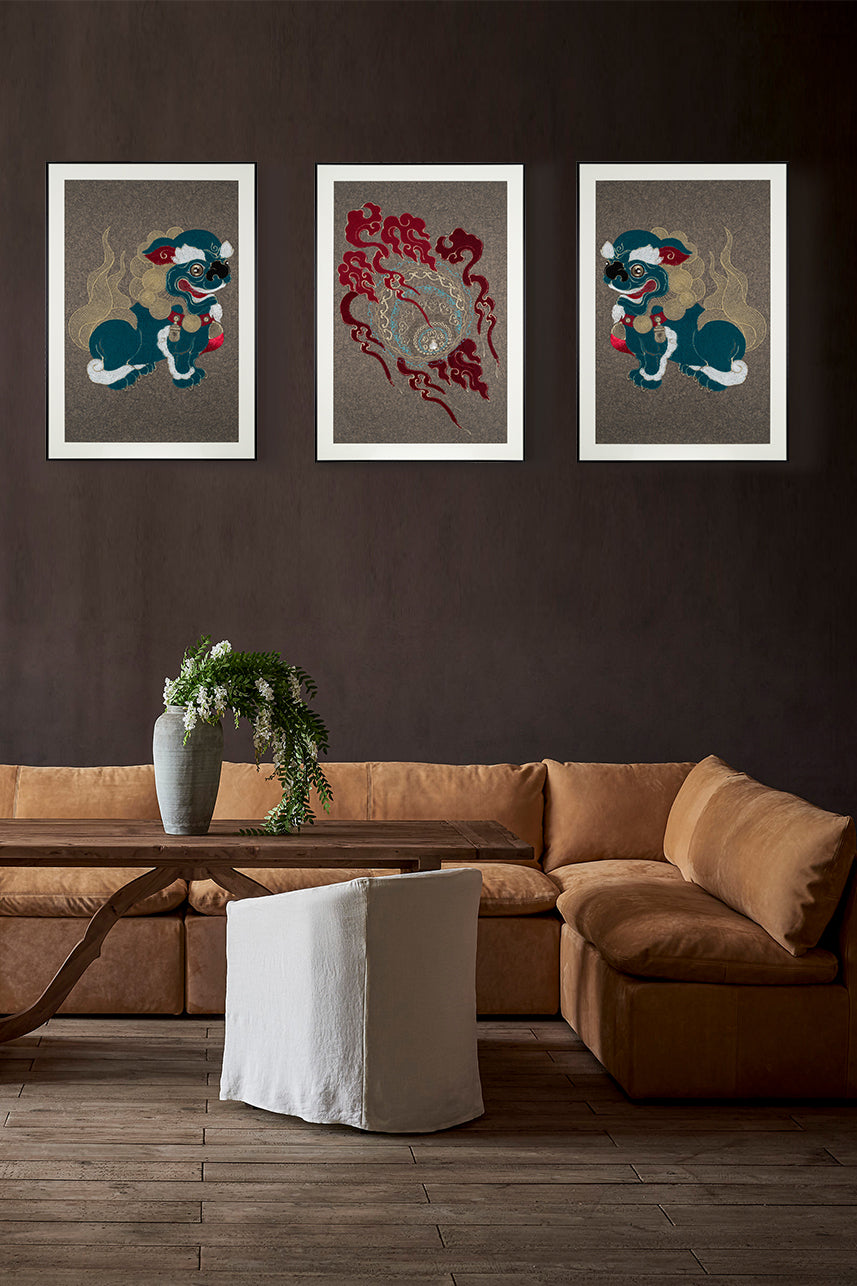 Framed embroidery artwork featuring a lion ball play design displayed on the right side over a sofa table.