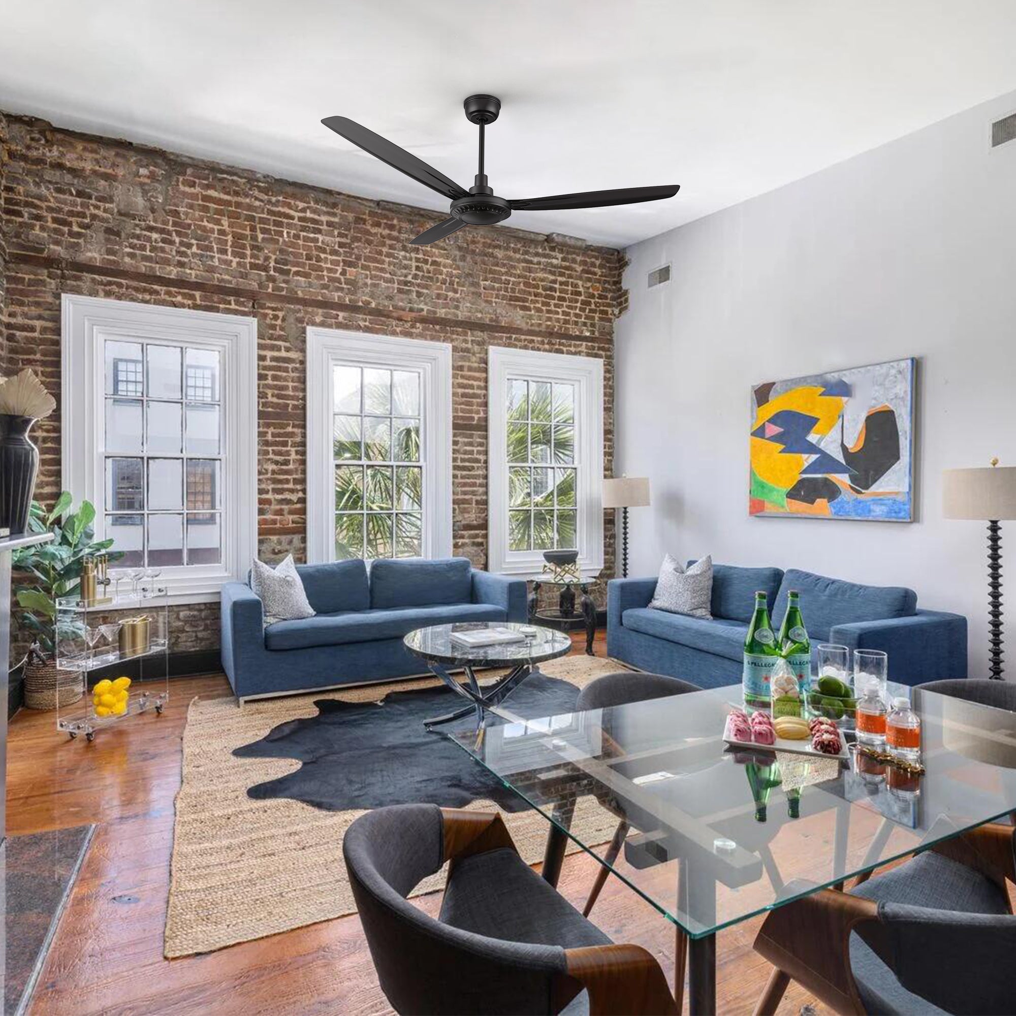 Alya 56-inch DC motor ceiling fan in black with a modern industrial design, showcased in a stylish living room. Features a 3-blade structure and downrod installation, perfect for high ceilings.