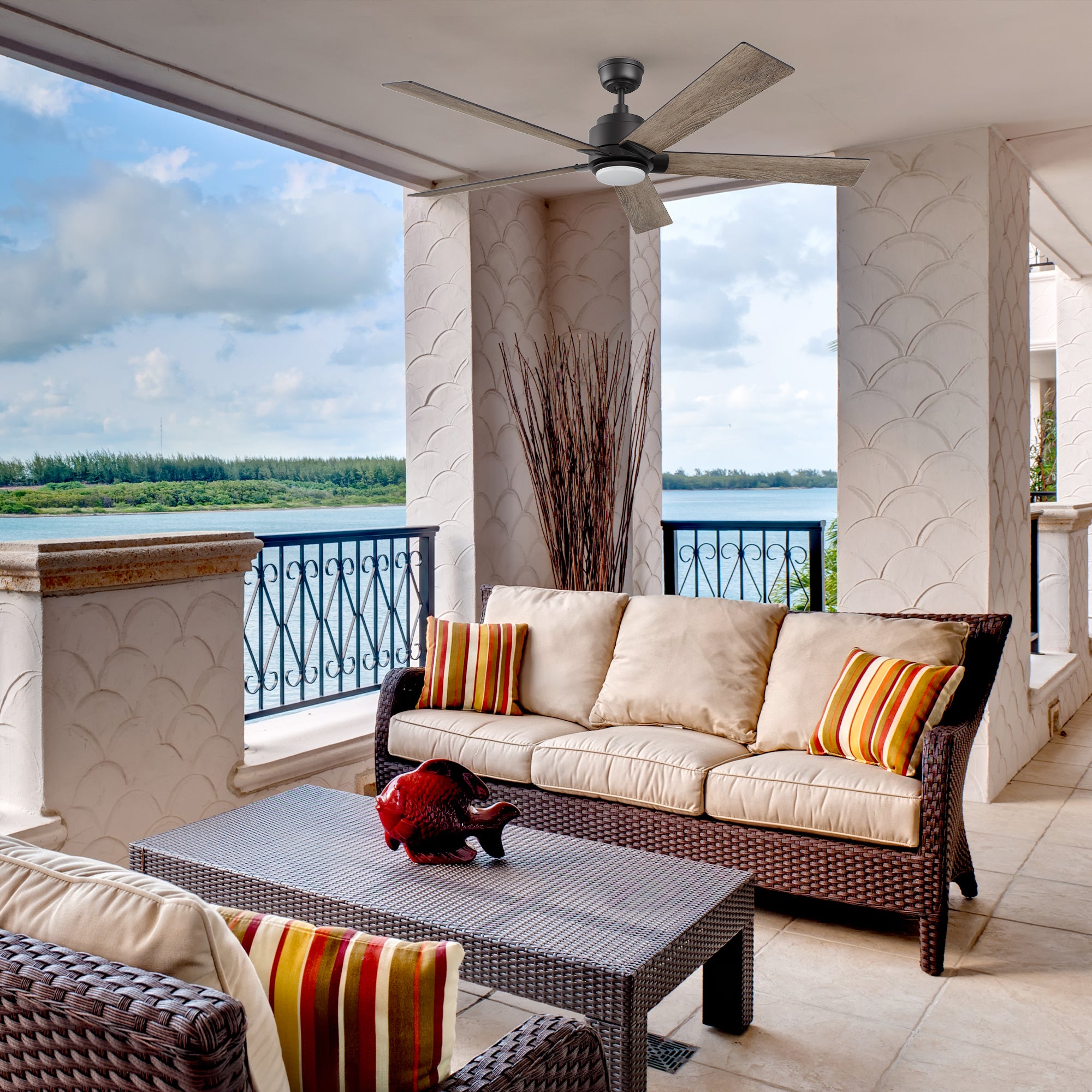 Outdoor covered balcony with the Aspen smart ceiling fan in black, offering quiet airflow and efficient cooling for relaxing spaces.