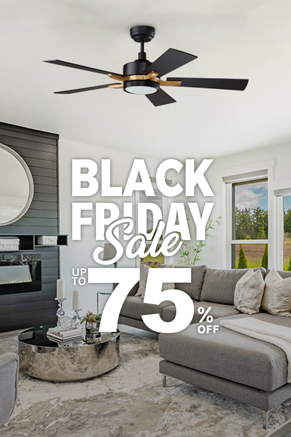 A modern, bright living room featuring Apex 52 inch black and gold smart ceiling fan with light. The room is decorated with a large, gray sectional sofa, a matching armchair, a round silver coffee table, and a rug. A black fireplace and a large round mirror are on one wall, while large windows offer a view of an open field. The image is overlaid with text promoting a "PRE-BLACK FRIDAY Sale" with "UP TO 75% OFF."