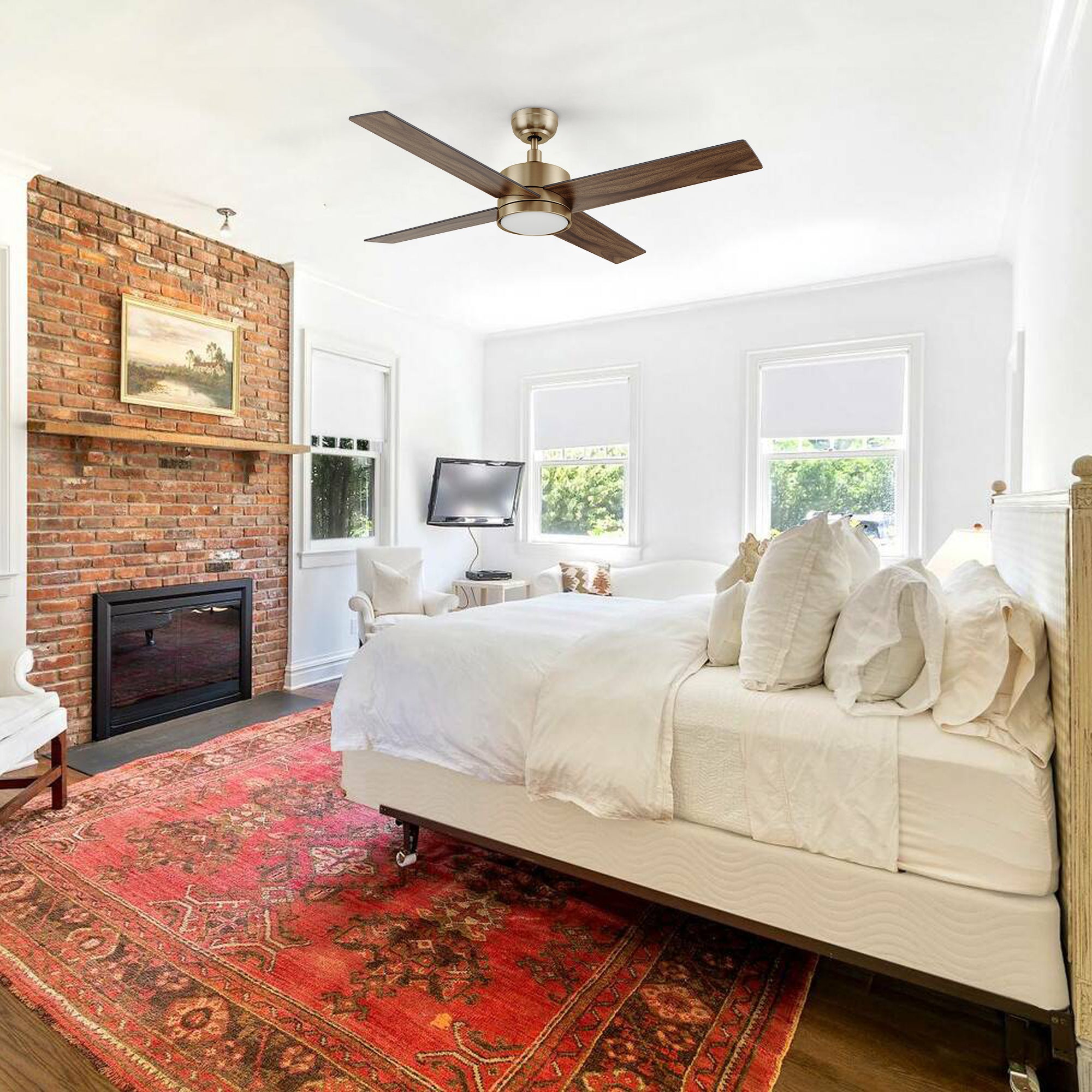 Scandinavian-style bedroom with the Carro Smafan Rossendale 52-inch ceiling fan in gold, mounted above a white bed and red rug.