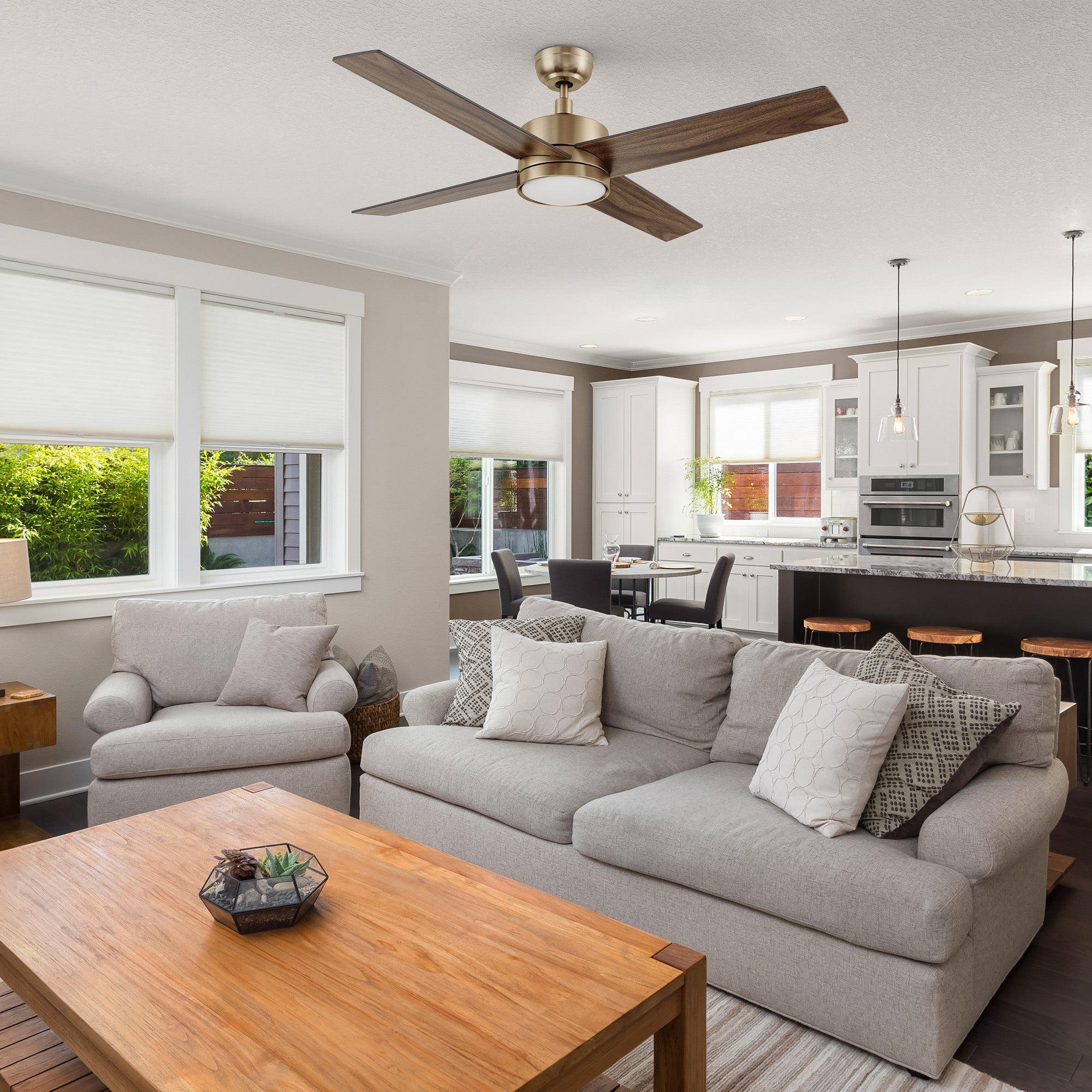 Modern living room featuring the Carro Smafan Rossendale 52-inch ceiling fan with LED light in a brushed gold finish.