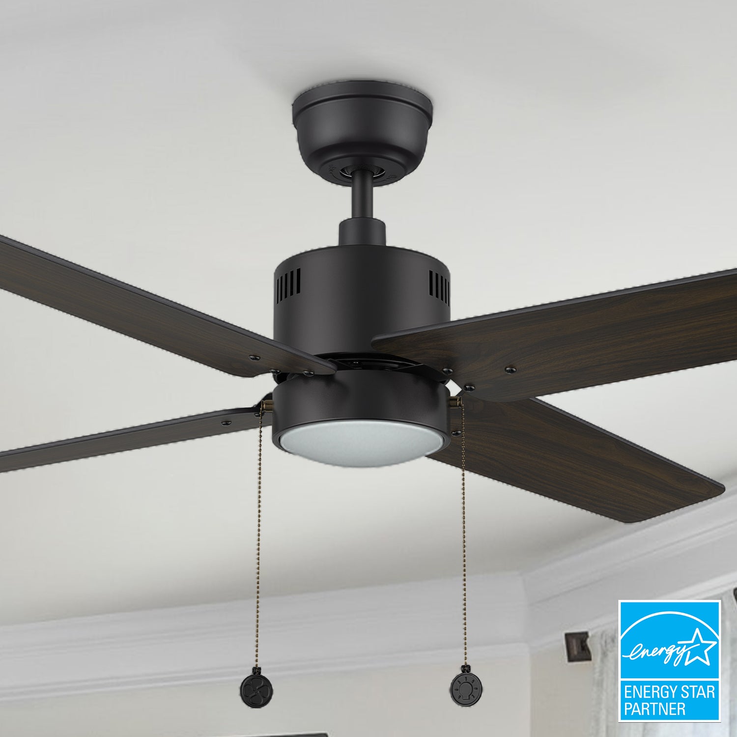 Carro Rowan 52 inch modern ceiling fan with LED light in a black finish, showcased in a spacious open living area.