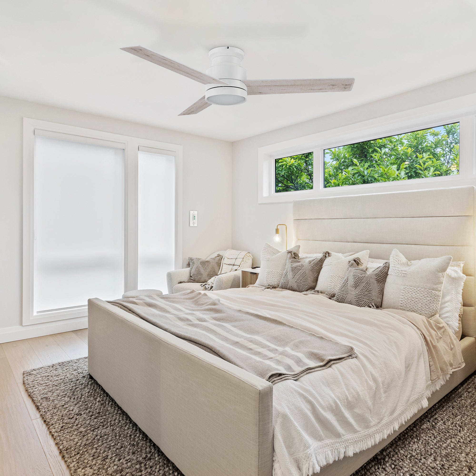 Low profile ceiling fan in white with LED light well matches to big beige bed, big linen rug, making the whole living room with a modern sense.