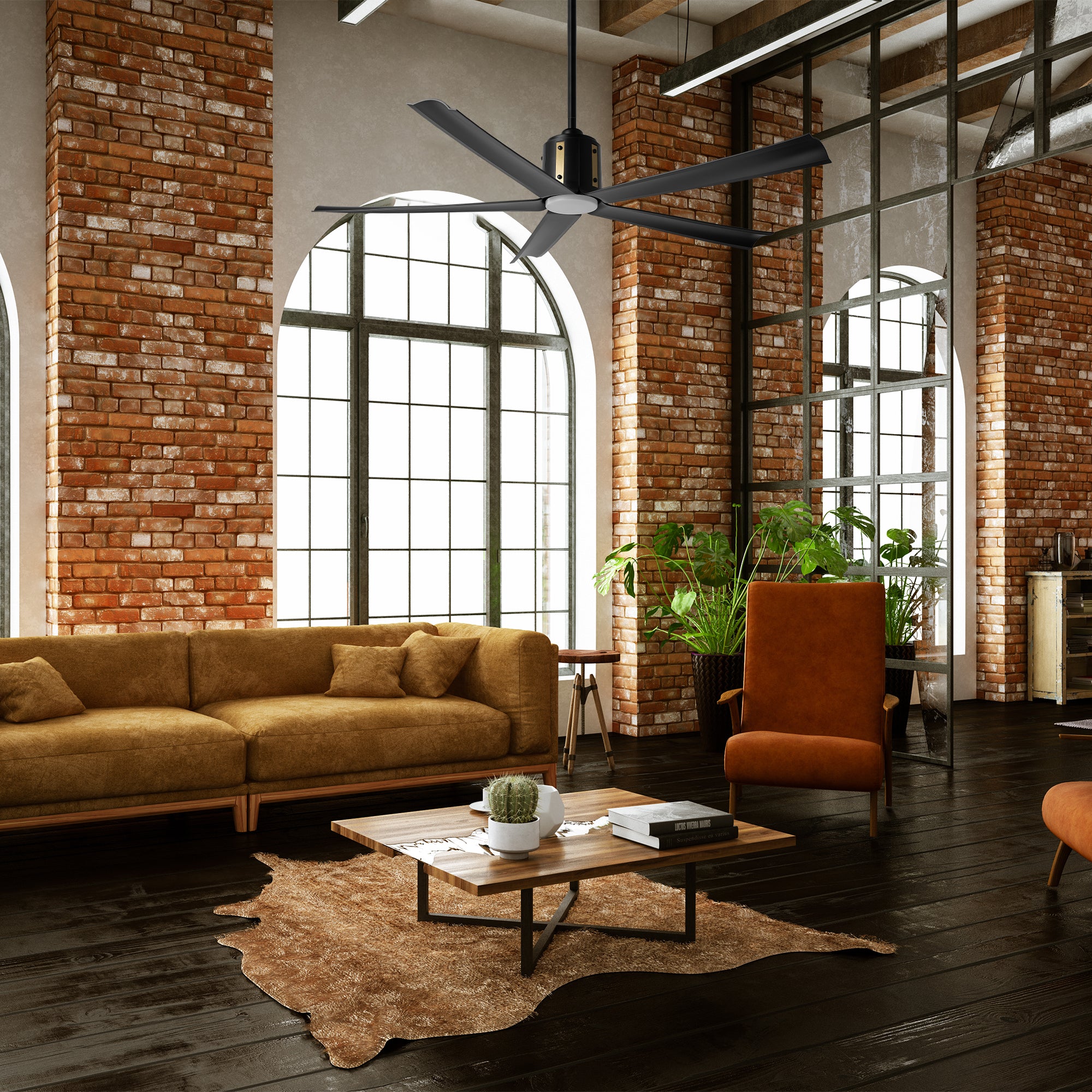 Industrial living room with exposed brick and Zahar 60" black & gold ceiling fan with LED light over tan sofa and cowhide rug. A quiet ceiling fan with powerful airflow.