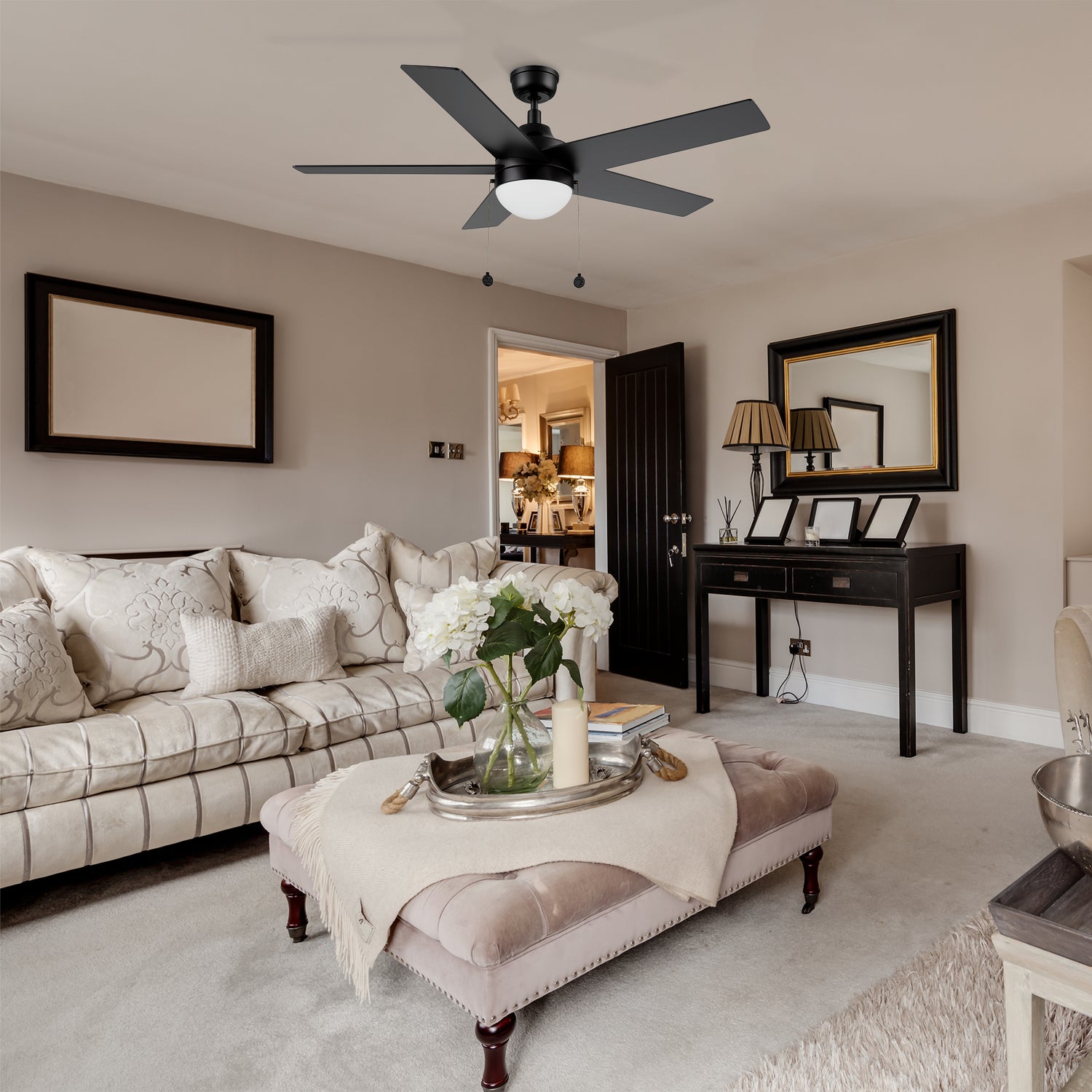 Black ceiling fan with LED light 52 inch matches to beige furniture, luxurious black gold frame wall mirror, the whole living room is noble and elegant.