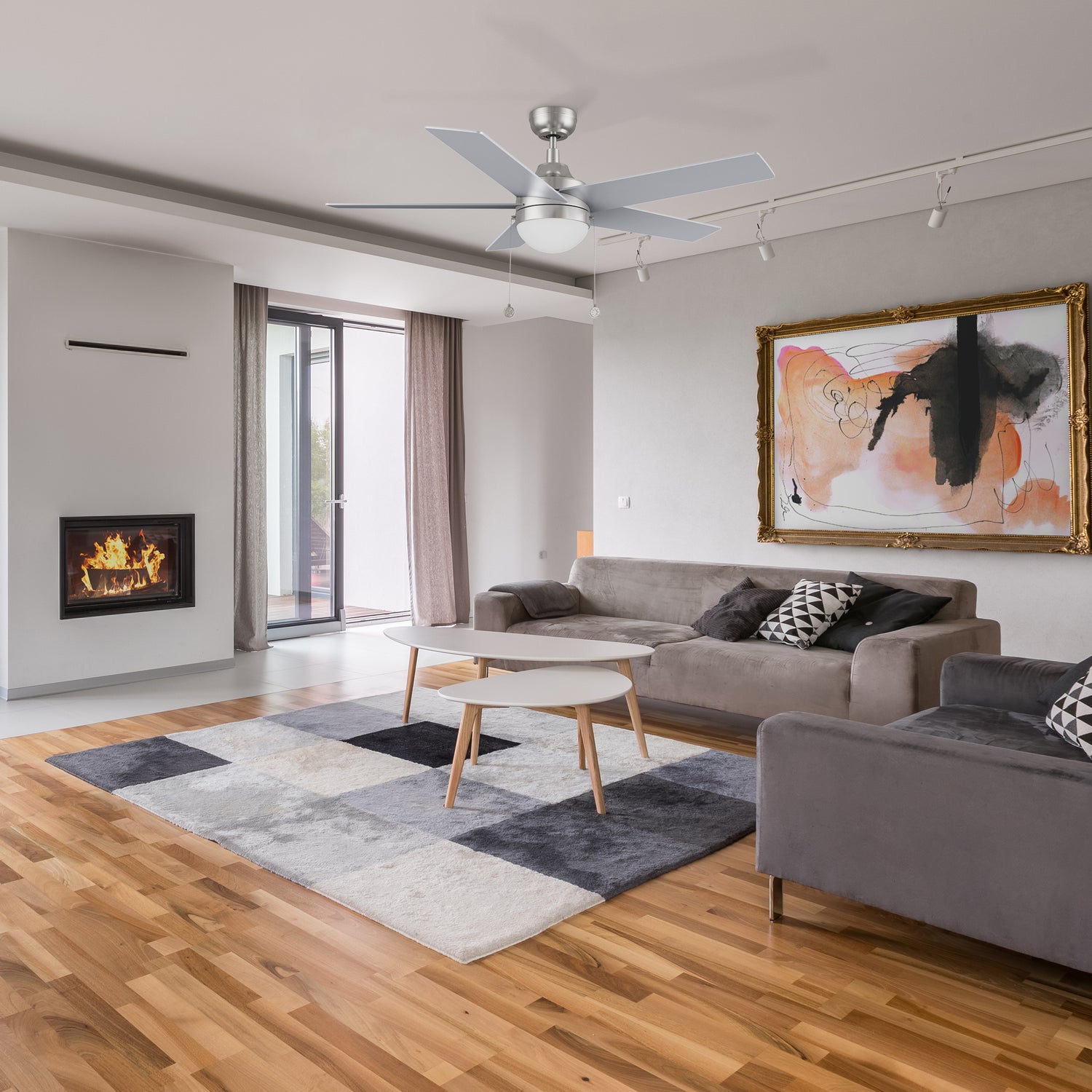 52 inch downrod mount silver ceiling fan with LED light goes well with the white, dark grey and dark blue coral velvet carpet in the living room.