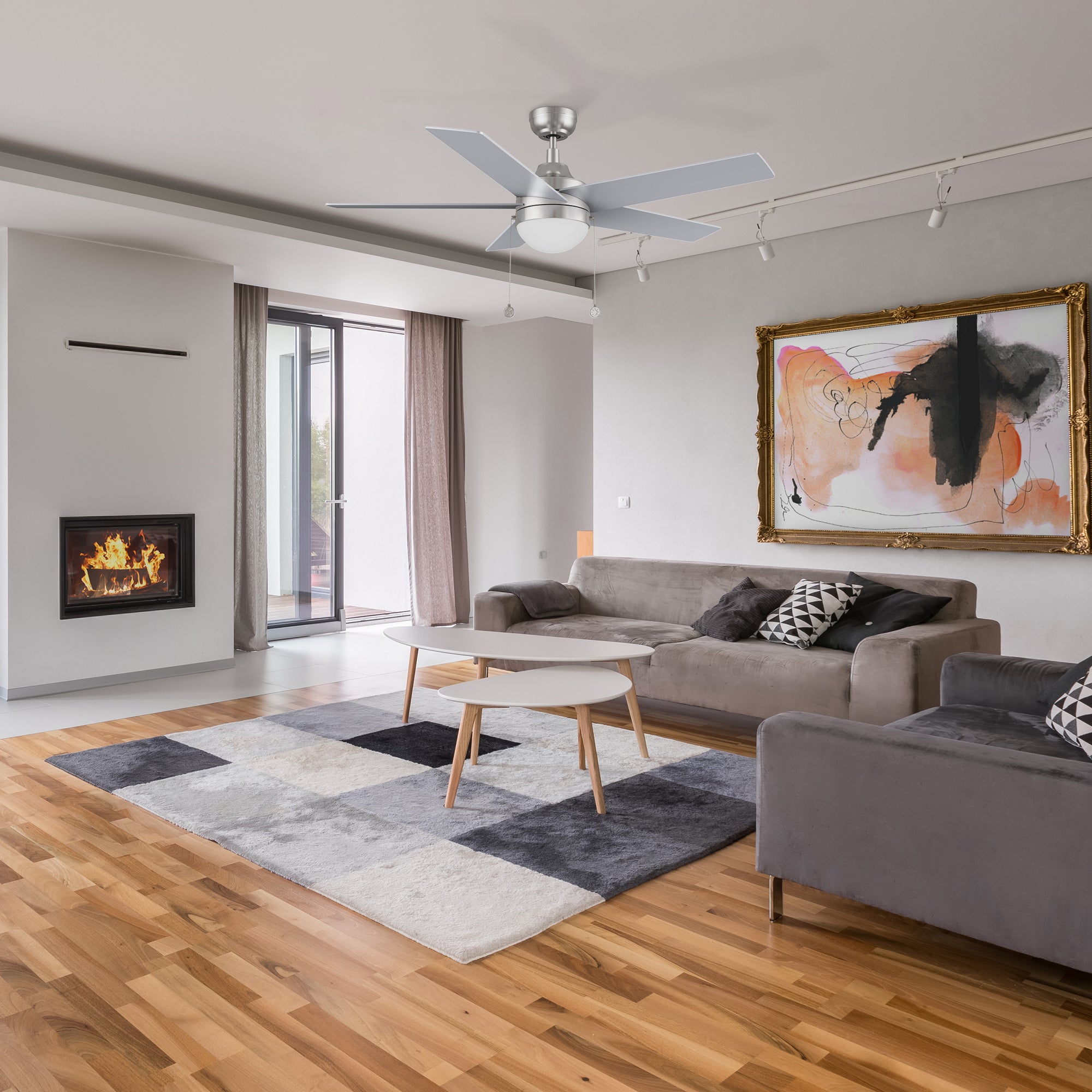 52 inch downrod mount silver ceiling fan with LED light goes well with the white, dark grey and dark blue coral velvet carpet in the living room.