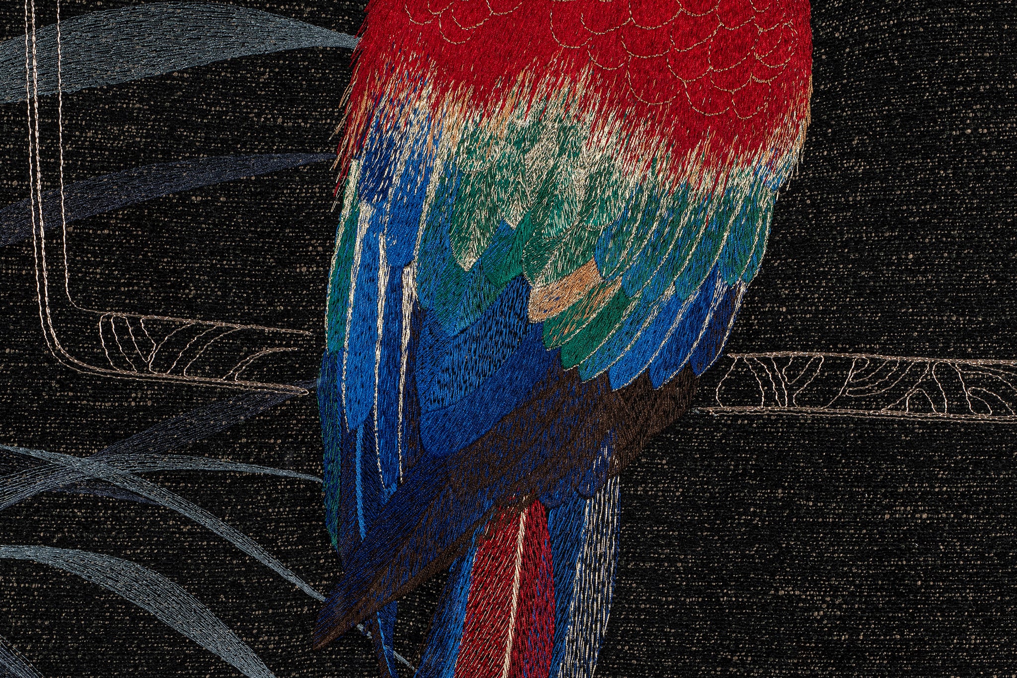 The embroidery wall artwork of parrot design's lower body details.