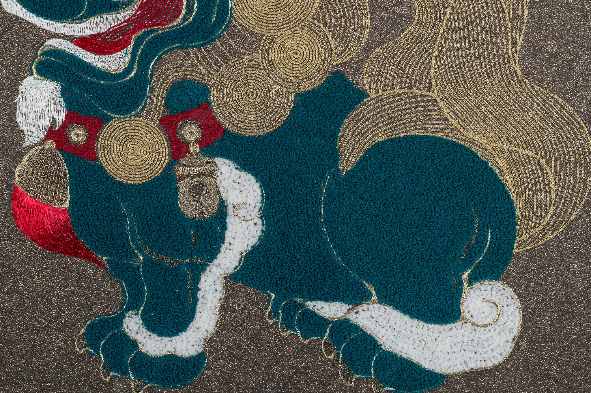 Close-up of framed embroidery artwork focusing on the intricate details of the lion design.