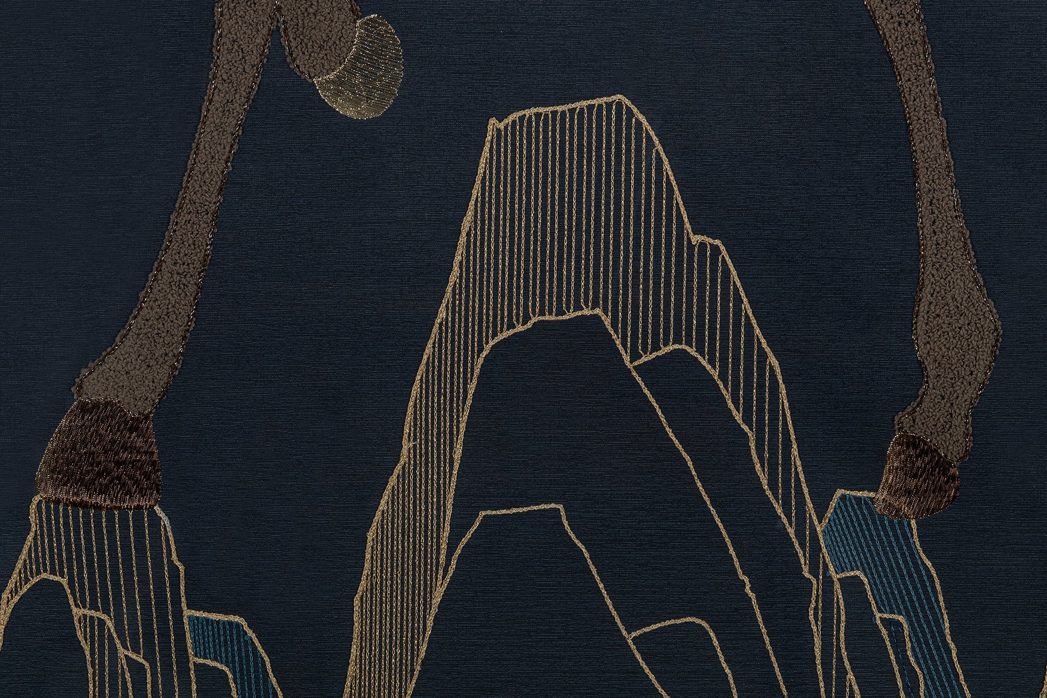 An embroidery artwork showcasing the intricate details of the mountains.