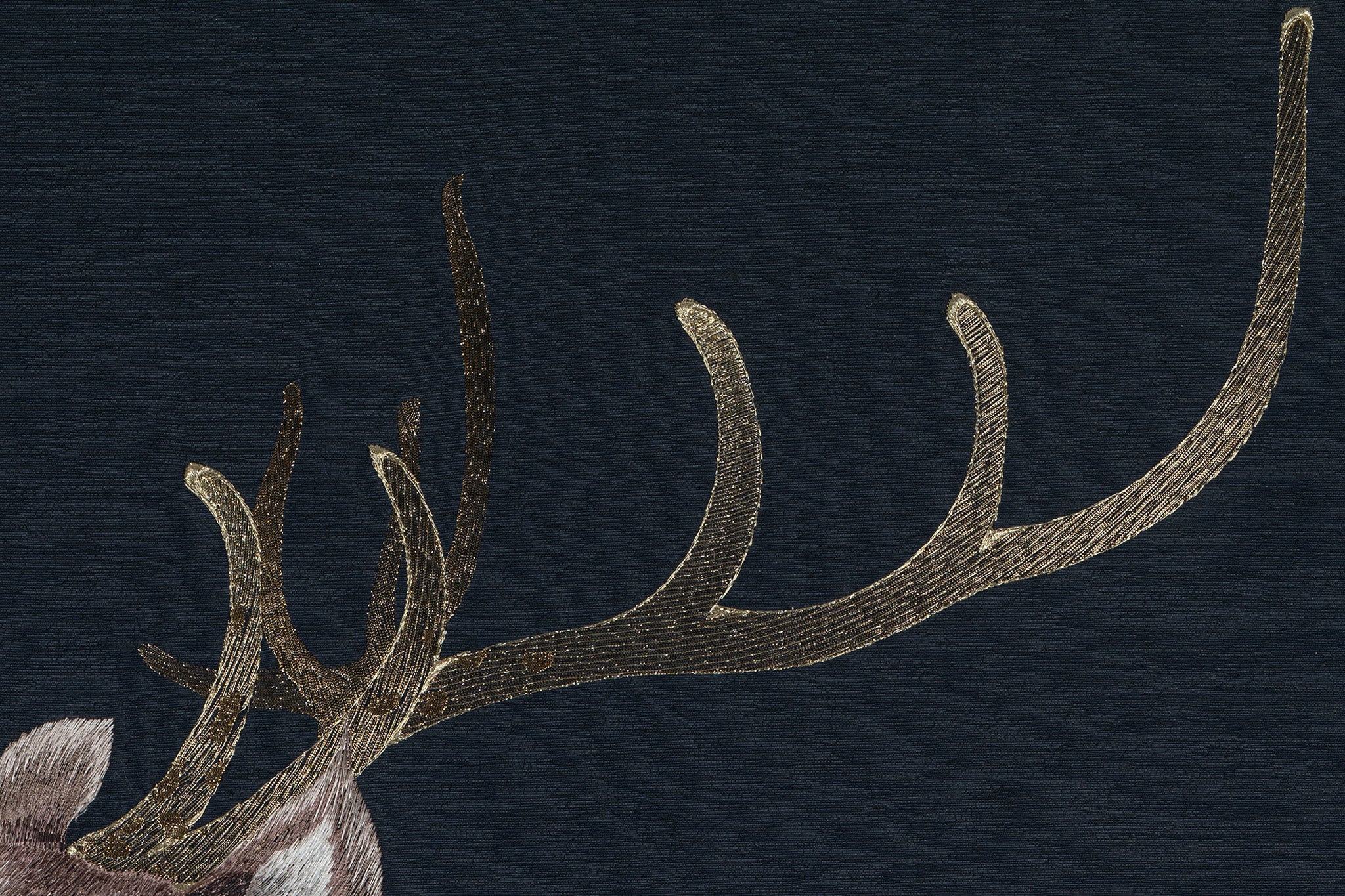 An embroidery artwork showcasing the intricate details of a deer's antlers.