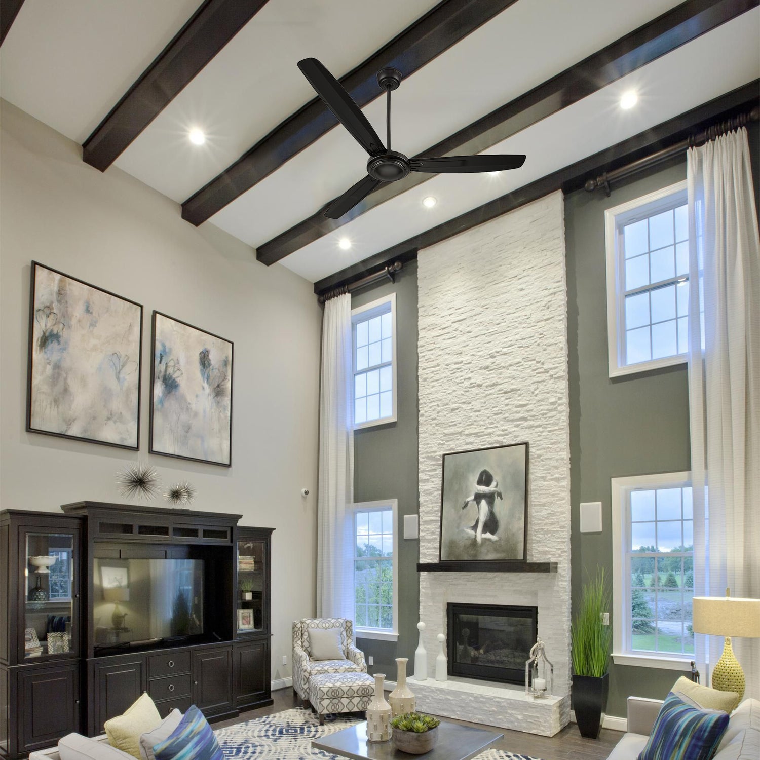 Kade 56-inch black ceiling fan installed in a modern living room, controlled by a remote and wall switch.  Features a sleek design, perfect for large spaces.