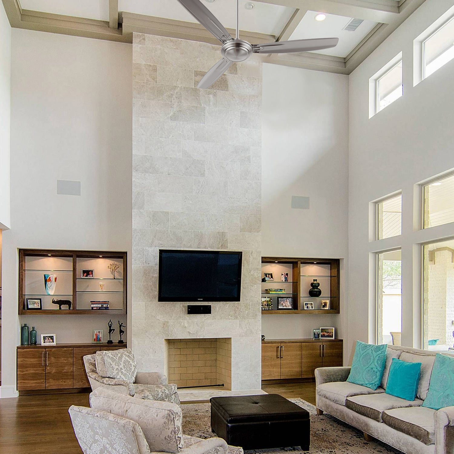 Kade 56-inch brushed nickel ceiling fan with remote control, cooling a modern living room with high ceilings. Silver finish adds elegance to contemporary decor.