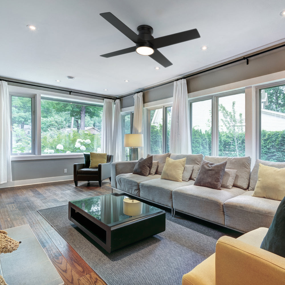 The image prominently features an Olinda 52" Flush Mount Ceiling Fan in Black with LED Light, seamlessly integrated into a modern living room setting. The fan&