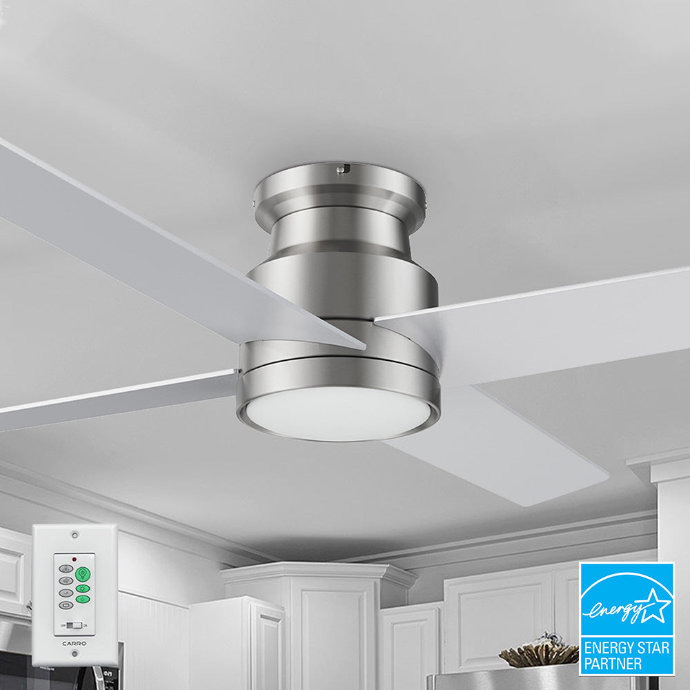 Modern 52-inch Olinda flush mount ceiling fan in brushed nickel with four white blades and an integrated LED light, shown with a matching white wall switch featuring fan and light controls.