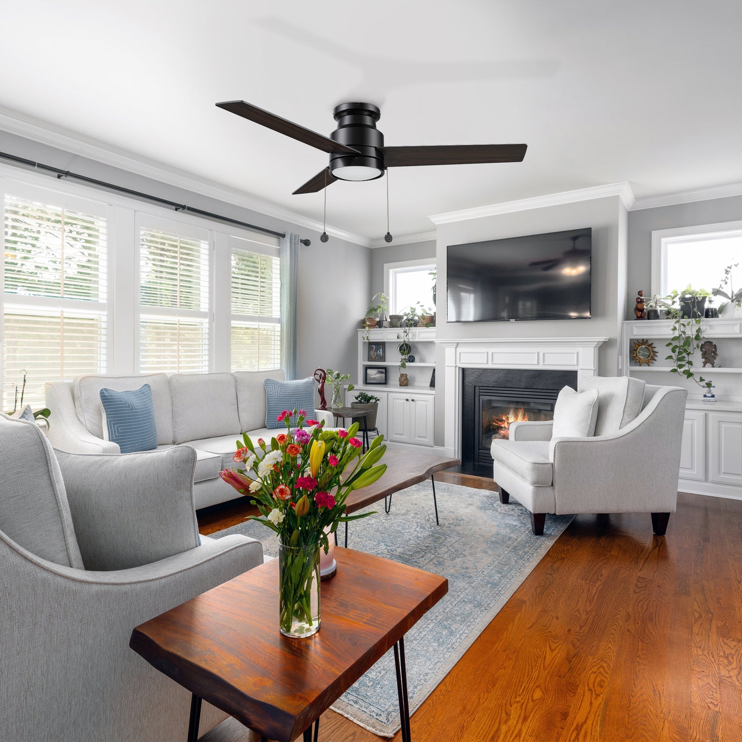 Black ceiling fan with flush mounting design, matching to light grey sofa, dark wood grain coffee table, LCD TV and stylish fireplace make the whole living room full of modern feeling.