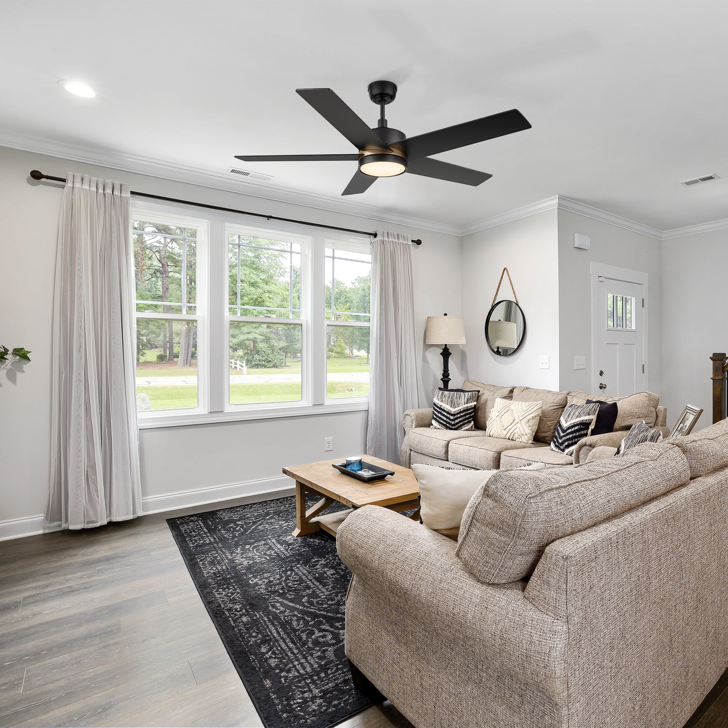 Carro Lakeland 52 inch smart ceiling fan with 5 blades and 4.5 inch downrod, black design, downrod mounted in a modern livingroom.