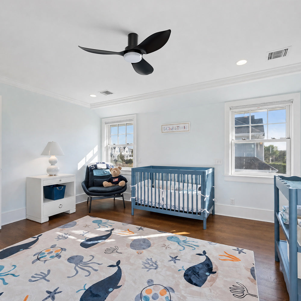 Smafan Nefyn 45 inch flush mount ceiling fan with LED light and remote installed in a modern nursery. The low profile black three-blade ceiling fan complements the bright kids&