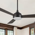 A Smafan Audra 52-inch modern black ceiling fan with LED light and reversible dark wood finish blades, mounted on a white ceiling with a downrod.