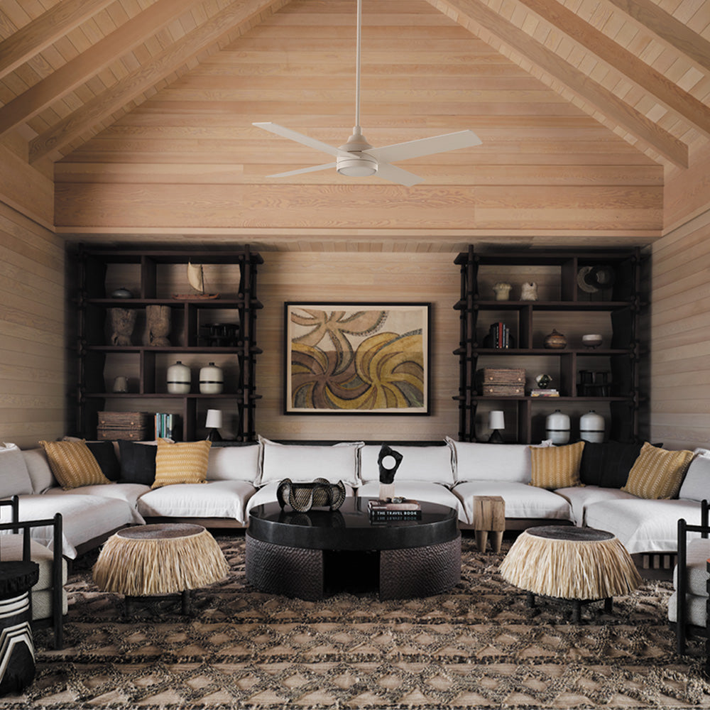Smafan Bryant 52 inch white ceiling fan with light mounted on a high vaulted wood ceiling in a tribal bohemian resort living room with large white sectional sofa and woven decor accents.
