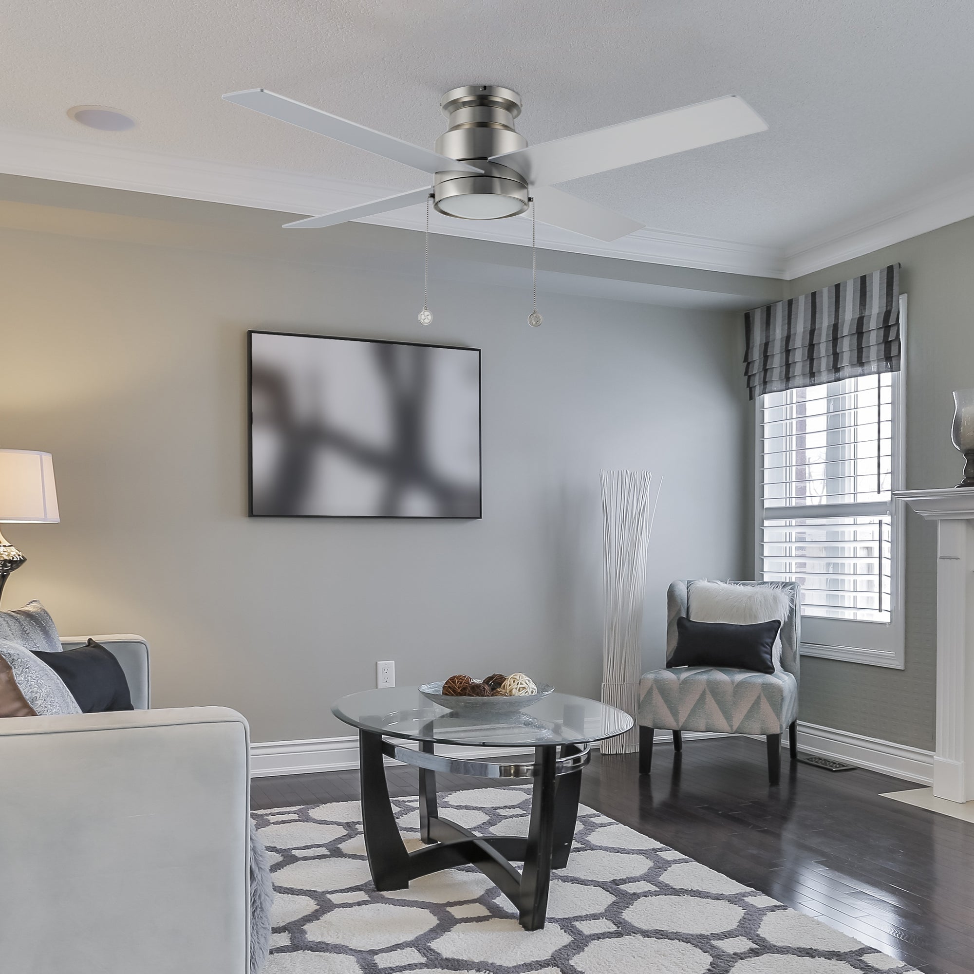 Carro Louy 52 inch modern ceiling fan with LED light in a silver finish, showcased in a spacious open living room area.