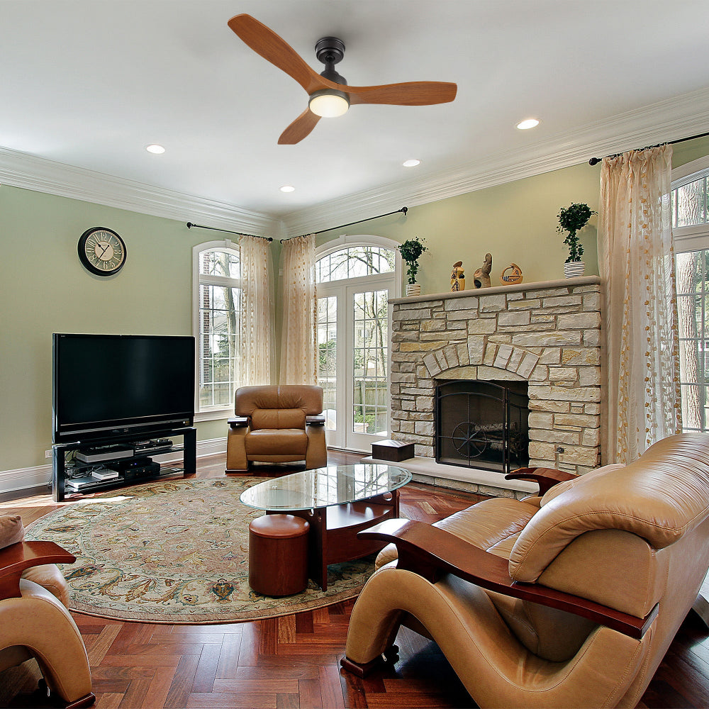 Rustic living room with stone fireplace and brown leather sofas featuring a 48-inch wood 3-blade ceiling fan with LED light and remote control.