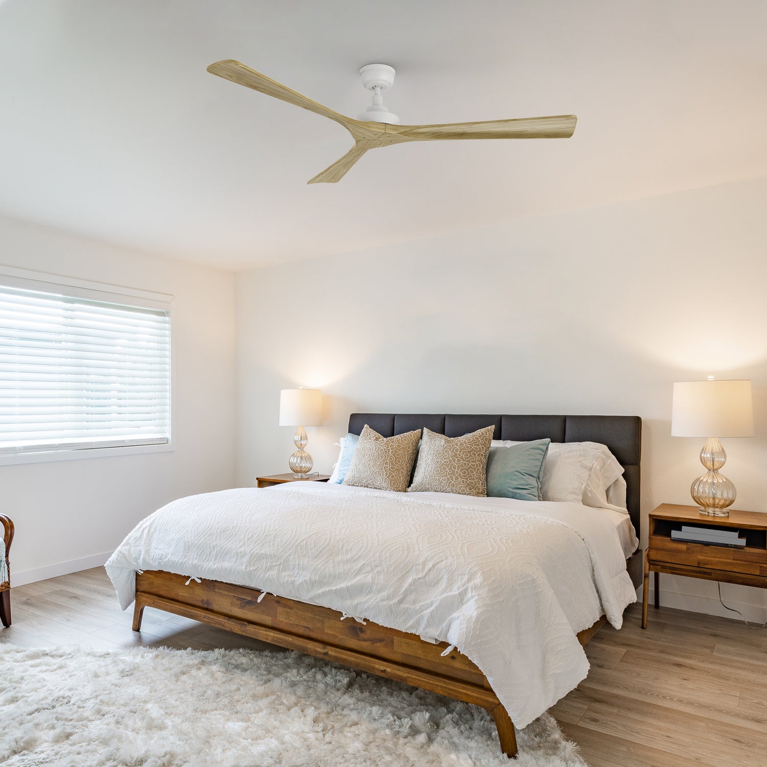 Thora 60-inch farmhouse ceiling fan with natural wood blades, installed in a cozy rustic bedroom. Equipped with a DC motor for energy-efficient cooling and quiet operation.