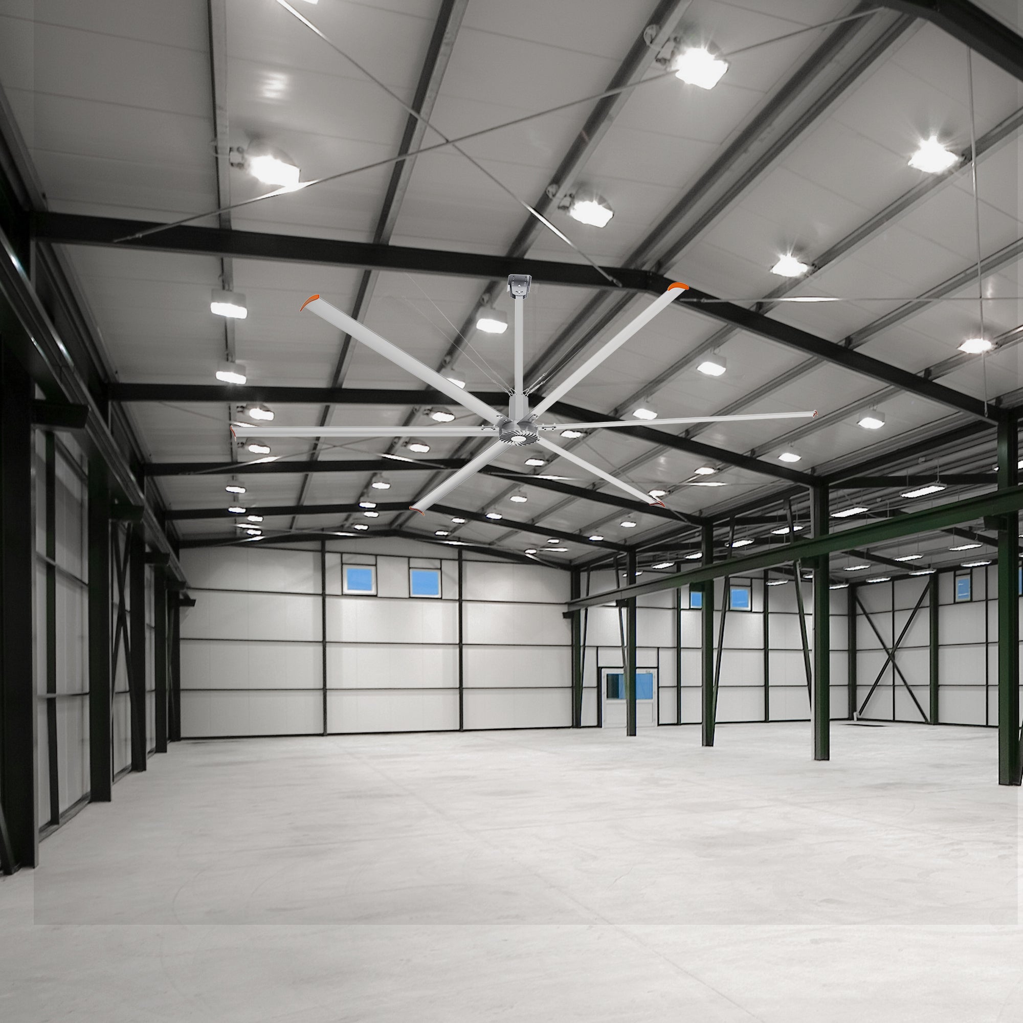 20 ft Industrial fan mounted on the ceiling of an empty warehouse.