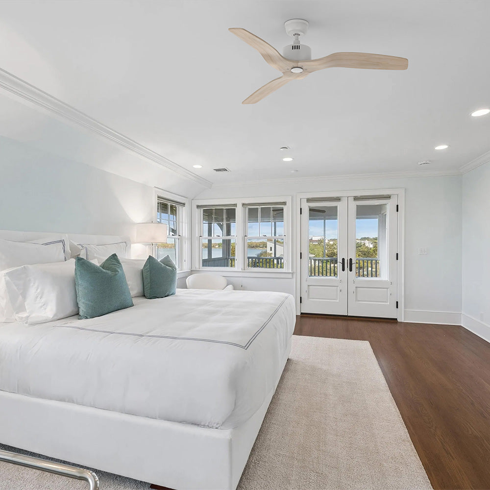 Yarmouth White ceiling fan with 3 light wood grain blades without light installed on a vaulted ceiling in a master bedroom.