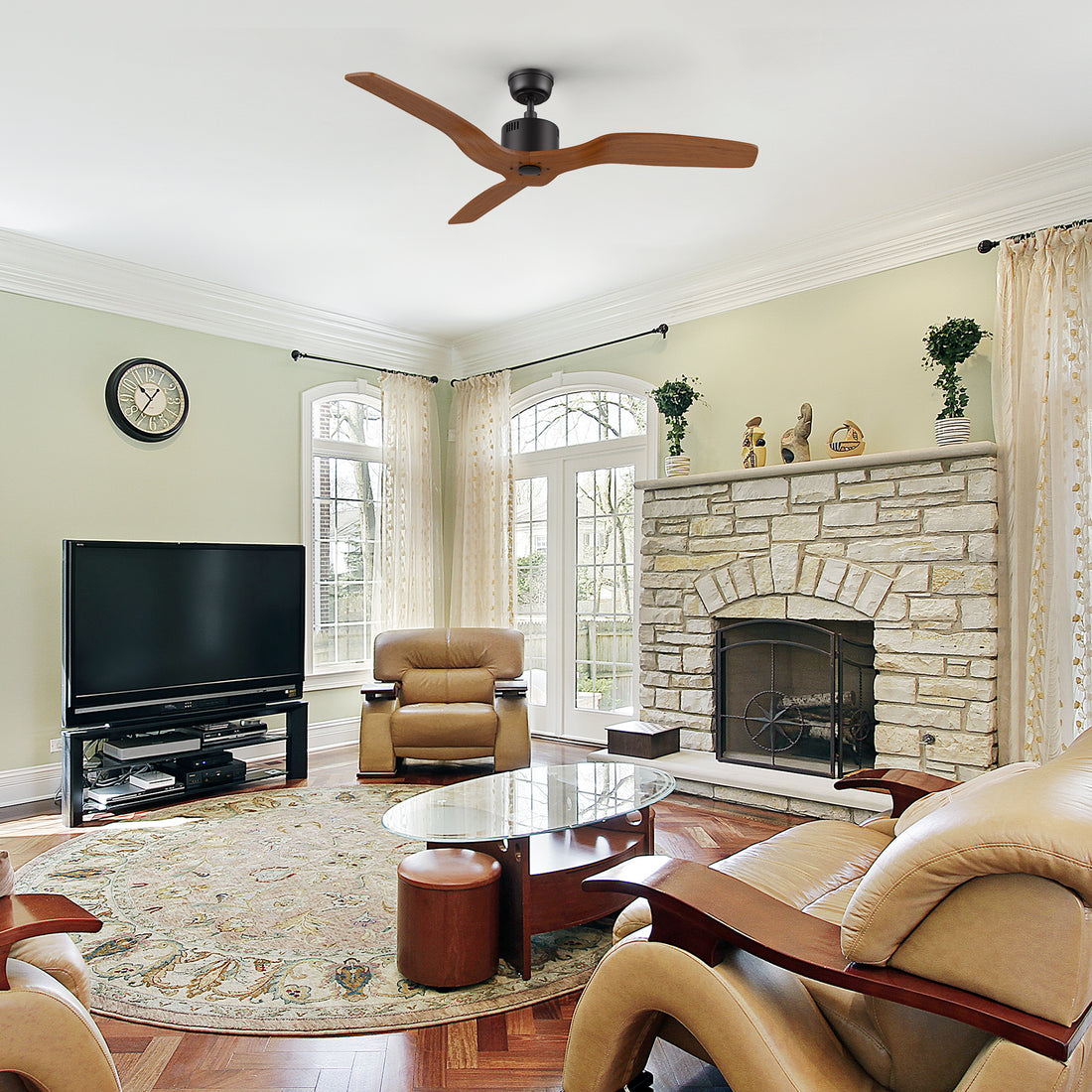 Yarmouth black farmhouse ceiling fan installed in a spacious living room, complemented by neutral furniture, a patterned area rug, and a cozy fireplace setting.