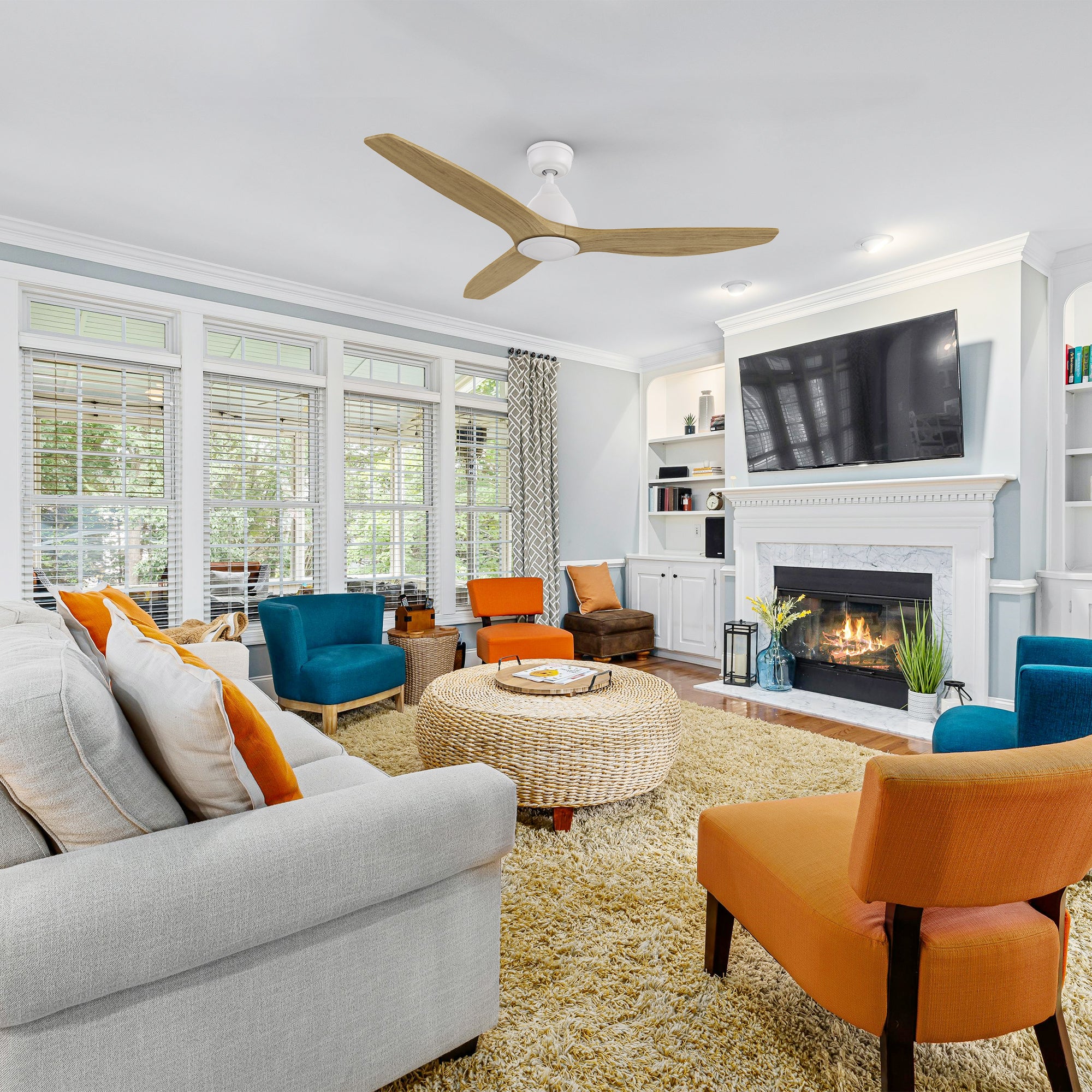 A modern living room with the Zircon ceiling fan installed. The fan features an energy-efficient DC motor, three solid wood blades, and a white motor housing, complementing the chic decor.