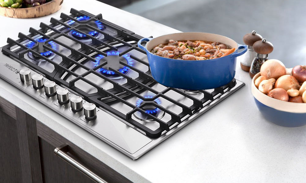 A bowl of Tom Yum Gong soup is heating up on a gas stove