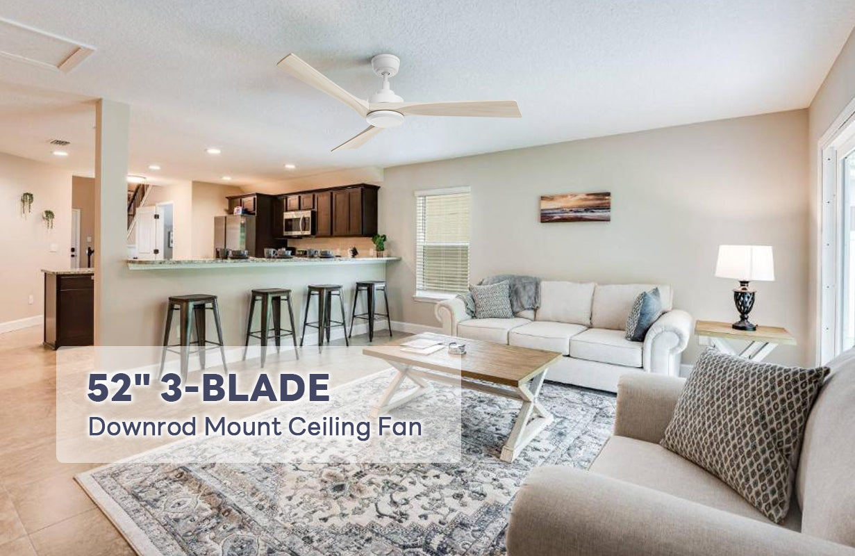 White downrod ceiling fan matches with large white patterned carpet, beige velvet sofa, and black table light with white lampshade make the living room look very luxurious.