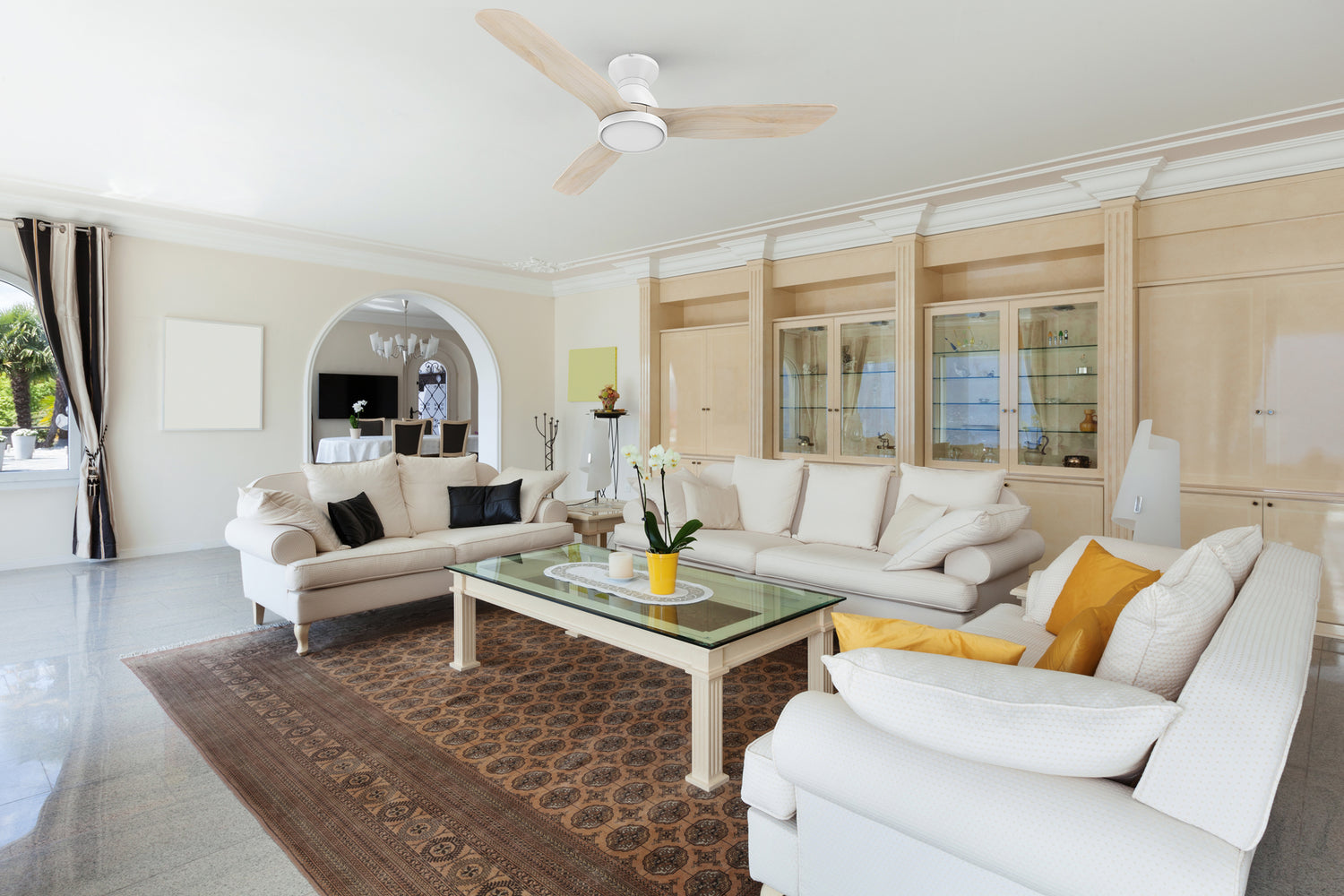 52-inch flush mounting ceiling fan with three solid-wood blades matching with ivory plush sofa, brown luxury carpet and light wood grain wall cabinet, making the living room more luxurious.