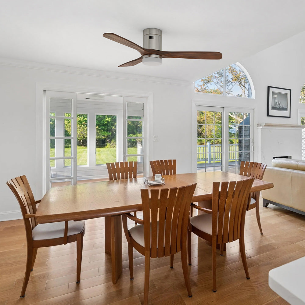 3-blade wood flush mount ceiling fan with light in bright open dining room.