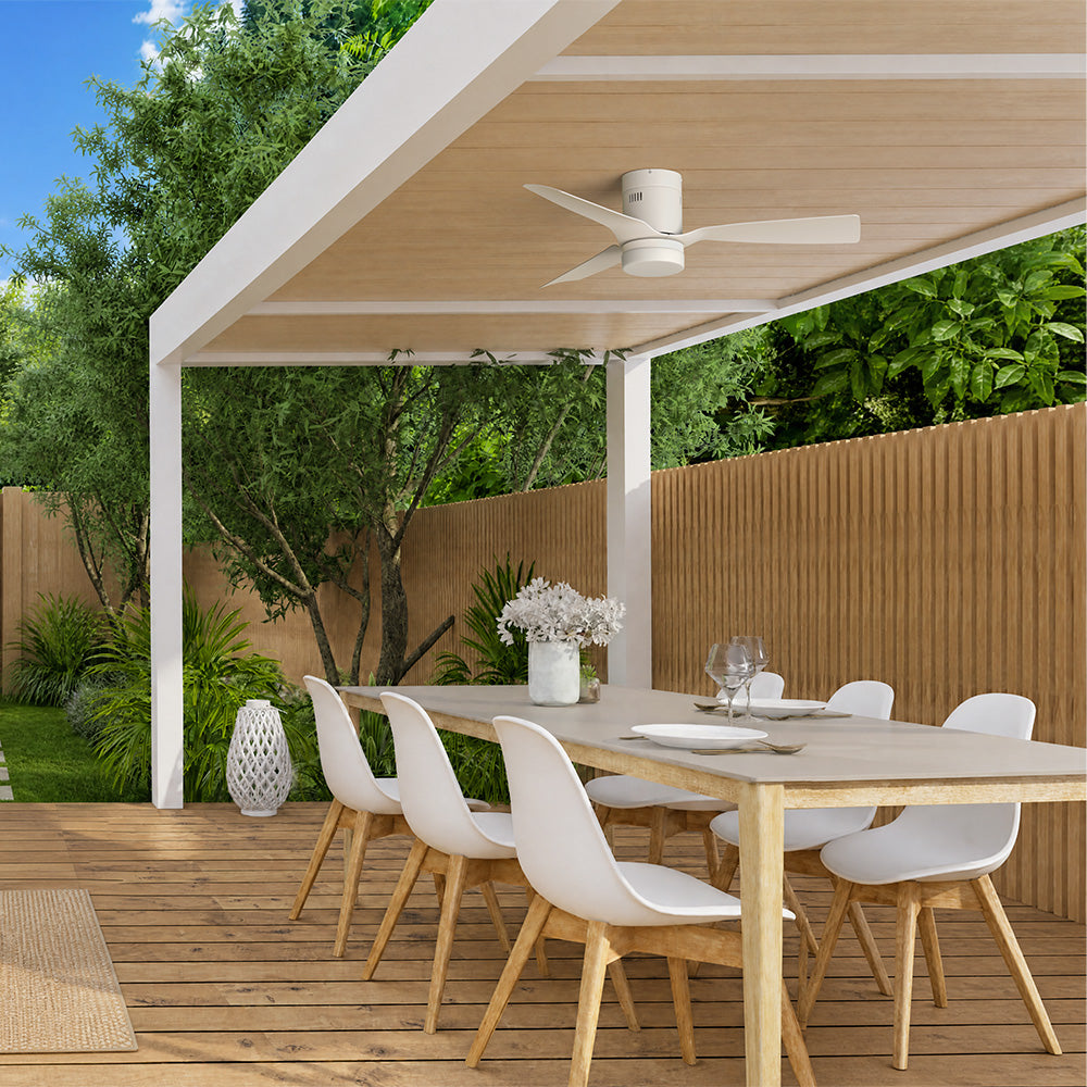 Smafan Striver 48 inch white flush mount outdoor ceiling fan with light installed on a modern pergola patio dining area with wood slat privacy fencing.