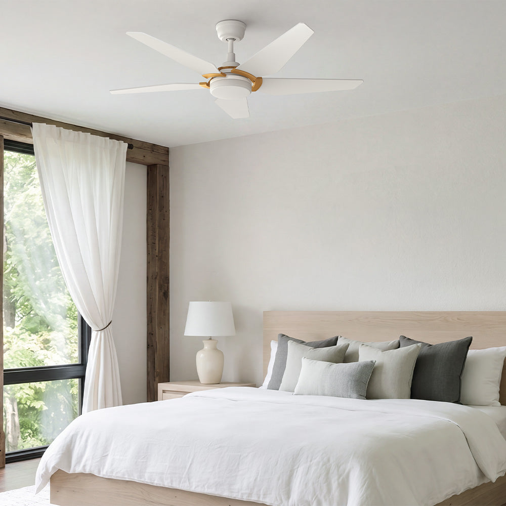 Smafan Voyager 52 inch white 5 blade ceiling fan with light and gold accent installed in a serene minimalist modern bedroom with natural light.