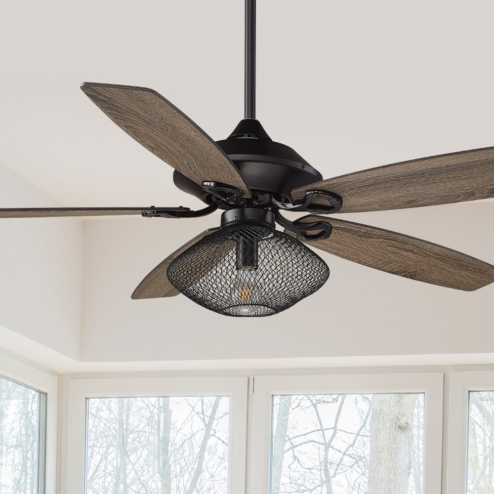 Carro Keller 52 inch ceiling fan with metal mesh lamp shade, light wood blades, and ornate blade connectors.
