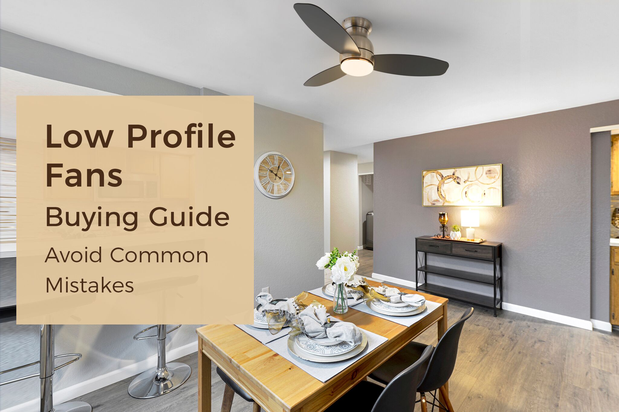 A brushed nickel, low-profile ceiling fan with light, 3 blades and an integrated light fixture installed in a dining room. The fan is positioned above a wooden dining table set for guests, with a living room area visible beyond.