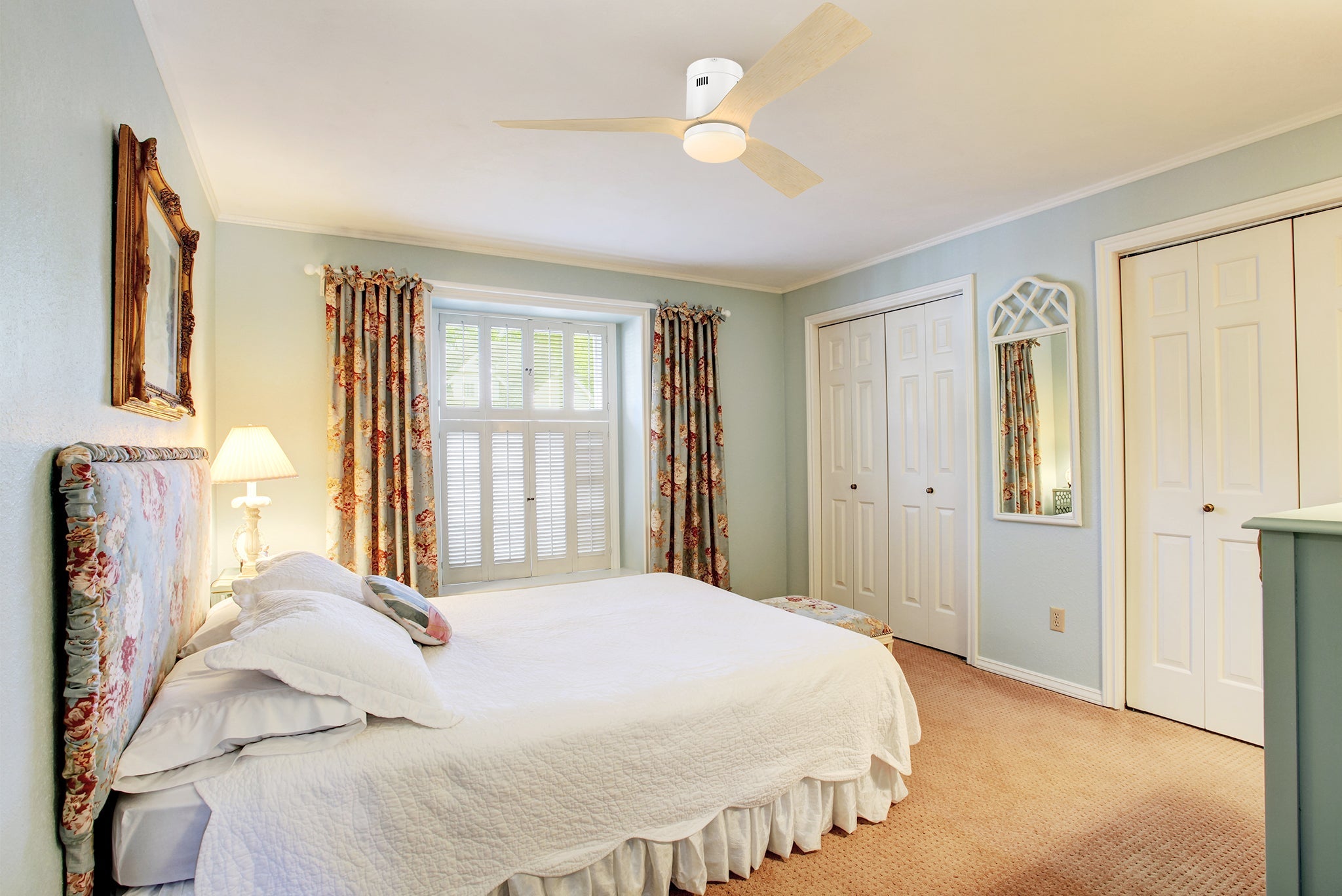 White low profile ceiling fan with wood tone designed blades was installed in bedroom