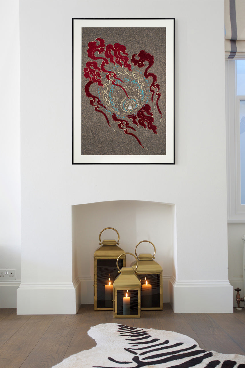 Framed embroidery artwork featuring a lion ball play design with ball patterns displayed over a fireplace. 