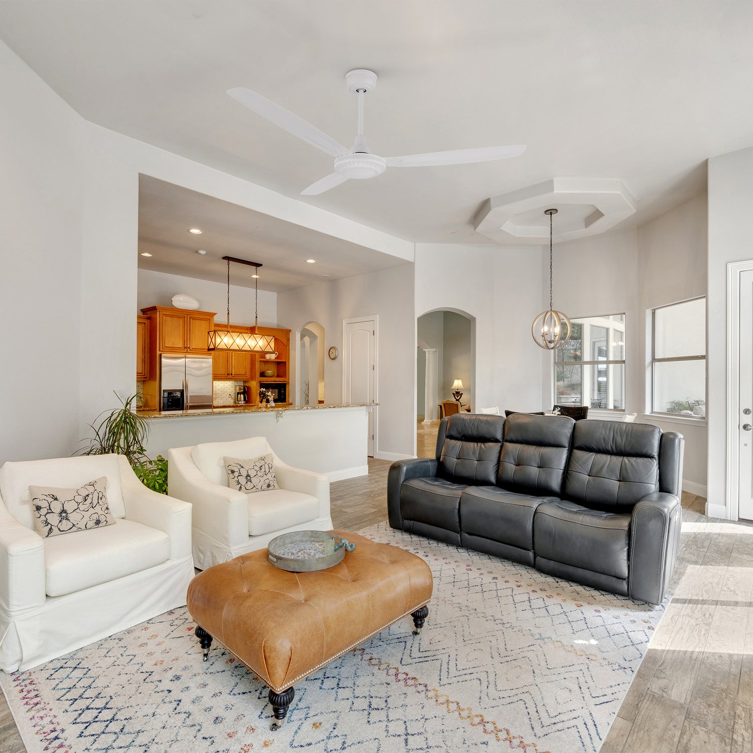 Alya industrial-style white ceiling fan with a quiet DC motor, displayed in a modern living room. 56-inch model with 3 blades, remote, and wall switch control. 