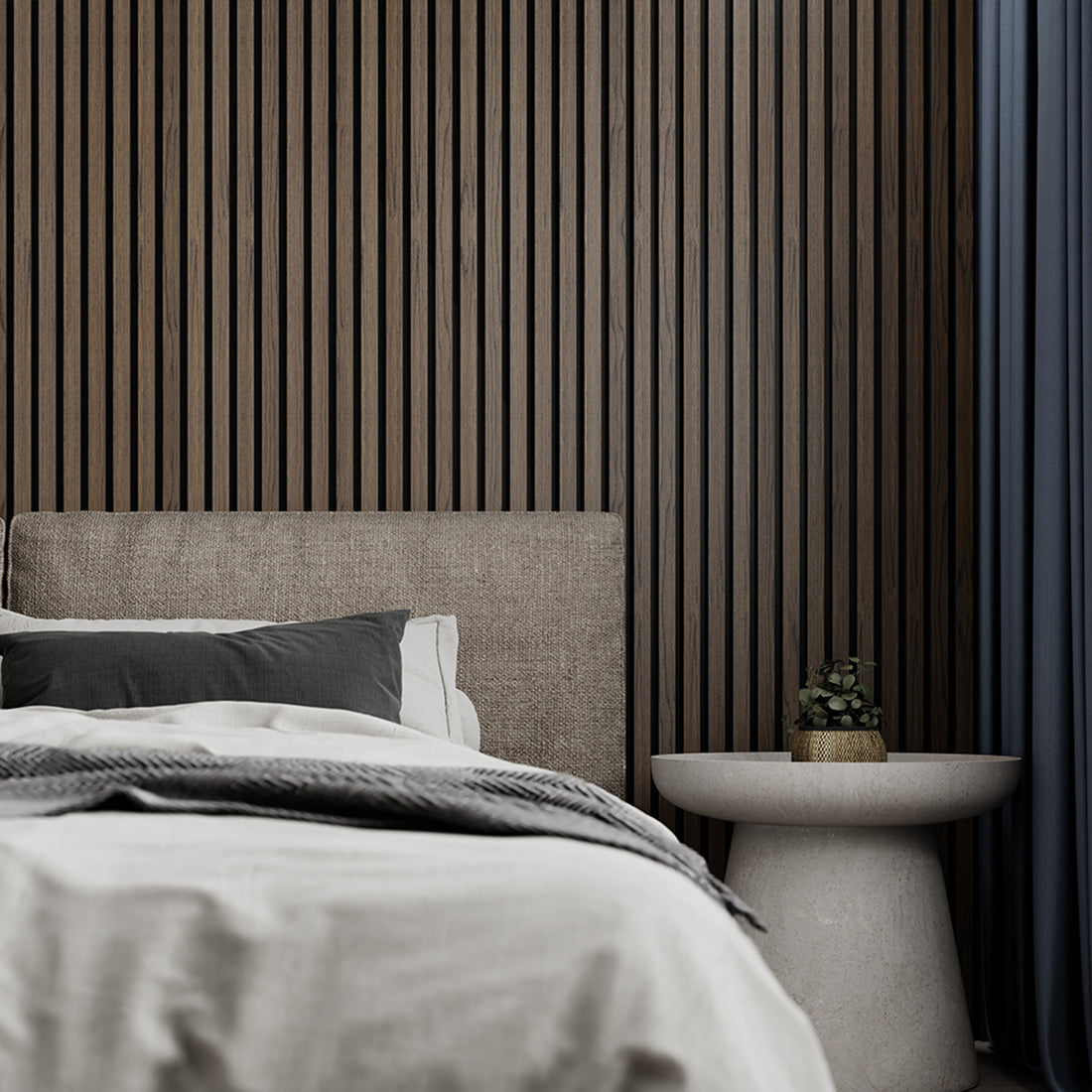 American Dark Walnut Acoustic Slat Wood Wall Panel installed behind a cozy bed setup with neutral bedding and a round side table, creating a warm and relaxing bedroom ambiance.