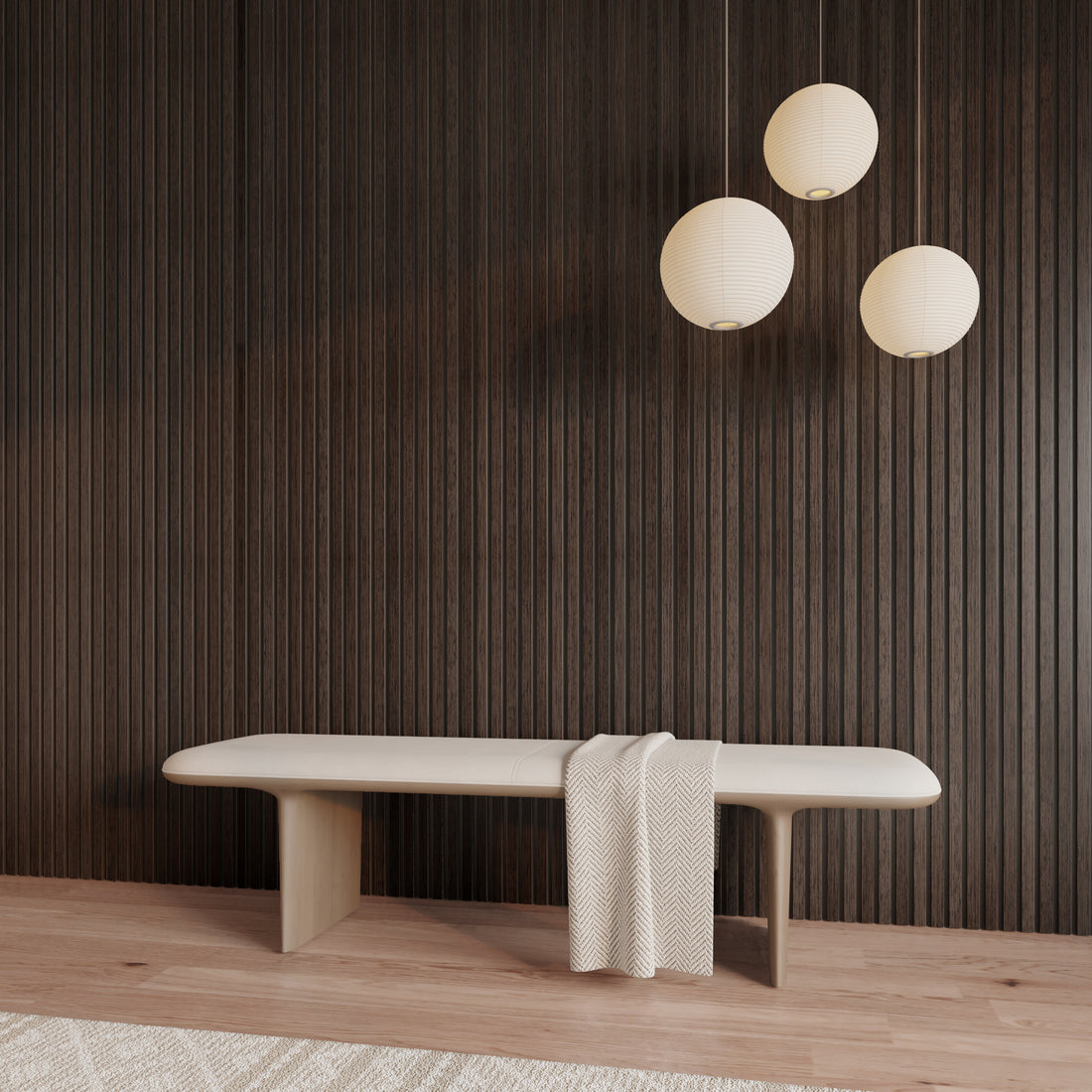 Minimalist interior with American Smoked Walnut acoustic slat wood wall panels, a light wood bench draped with a textured throw, and three modern round paper pendant lights, creating a warm, refined contrast against the dark wall.