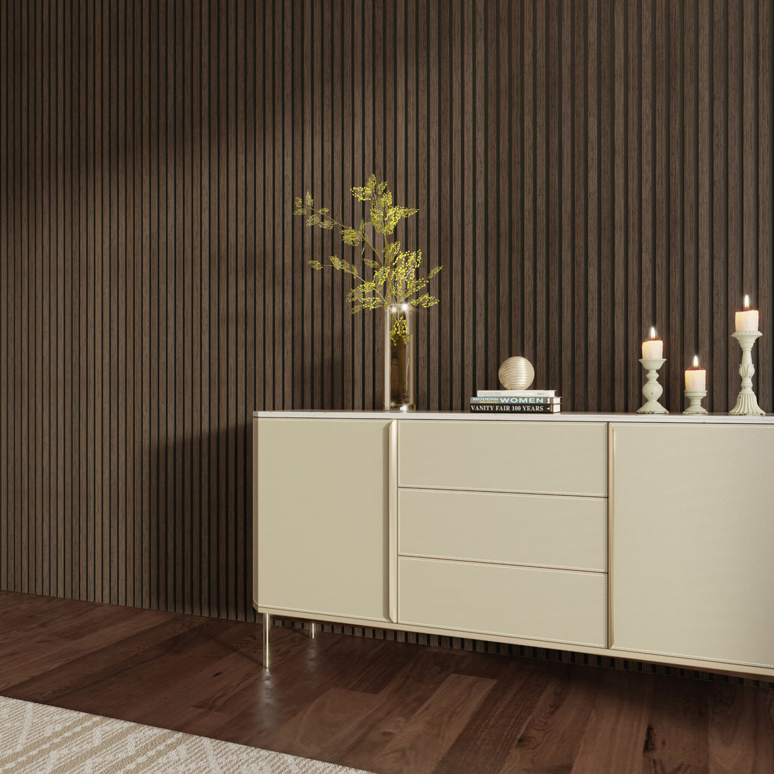 Interior scene featuring an American Smoked Walnut acoustic slat wood wall panel as the backdrop. A sleek beige sideboard stands against the wall, decorated with candles, books, and a tall vase with green branches. The dark wood flooring and vertical slat design add warmth and sophistication to the space.