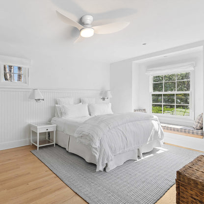 45 inch white flush mount ceiling fan with dimmable LED light and remote in modern bedroom. 
