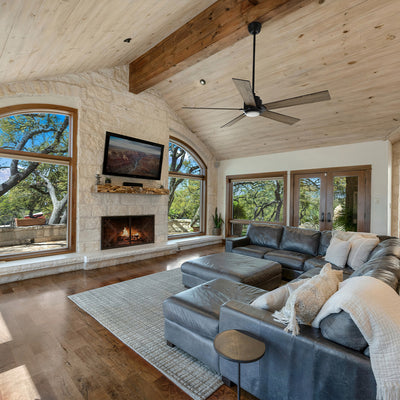 Black and wood ceiling fan in a farmhouse living room with warm neutrals