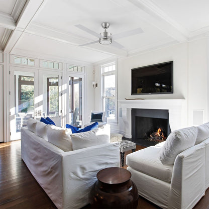 Smafan Rossendale 52-inch brushed nickel ceiling fan in silver with LED light installed in a coastal-style living room featuring white sofas and natural light. 